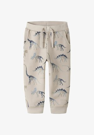 Pantaloni sport bej pentru copii cu modele de schelete de dinozauri în nuanțe de albastru și gri, având talie elastică și șnur de strângere.