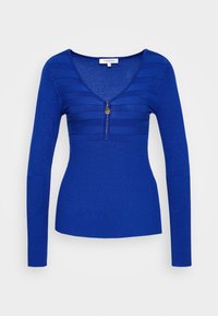 Blue long-sleeve top with a v-neckline, featuring horizontal stripes and a front zipper detail. Made of a smooth, ribbed knit fabric.