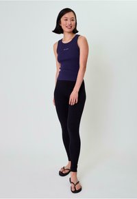 Granatowy, ribbed tank top z okrągłym dekoltem, w zestawieniu z czarnymi legginsami i czarnymi klapkami, minimalistyczny design, gładka faktura.