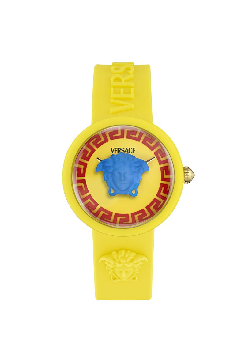 Dzeltena gumijas pulksteņi ar zilu Medūzas emblemu, sarkanu grieķu atslēgu rakstu un zeltītām stundiņas un minūtes rādītājiem. "Versace" logo uz siksniņas.