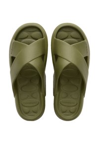 Green slide sandals with a cross-strap design, made of soft material. Textured footbed with circular patterns. Brand name visible on the sole.