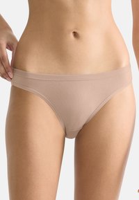 Beige Bikiniunterhose aus Baumwollmischung mit glatter Textur, minimalistischem Design und breitem Taillenbund, bietet volle Abdeckung und nahtlose Kanten.