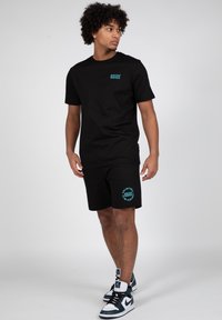 Wrong Friends SAFI - Tracksuit bottoms - black