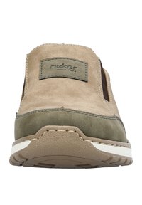 Tan leather slip-on shoe with green accents, elastic side panels, stitched detailing, and a beige rubber sole. Features a "rieker" brand label.