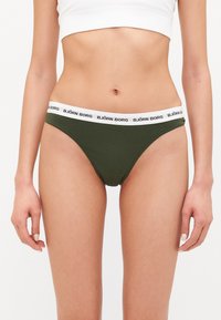 Olive green bikini brief with a white elastic waistband featuring the "BJÖRN BORG" logo. Soft fabric and low-rise design.