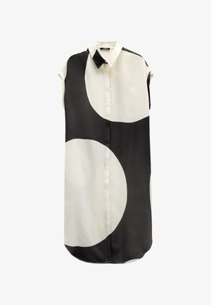 Koszula krótko rękawowa, zapinana na guziki, w jasnym kremowym i czarnym kolorze z dużymi geometrycznymi okręgami. Gładki, lekki materiał, zaokrąglony dół.