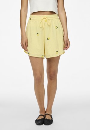Gule bomuldsshorts med elastisk talje og snor, prydet med broderede ananasdesigns på stoffet.