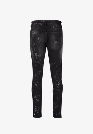 Zwarte spijkerbroek in skinny fit met een spettereffect in wit en blauw, vijf zakken en een standaard tailleband ontwerp.