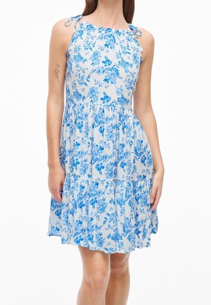 Floral print sundress with blue flowers on a light background. Features elastic neckline, adjustable tie straps, and tiered skirt.