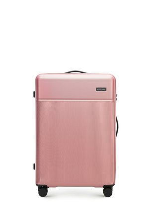 Hard-sided pink suitcase with vertical ribbed texture, top handle, side handle, and four black wheels for easy mobility. Brand logo displayed.