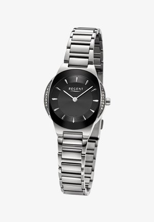 Montre-bracelet en métal argenté avec cadran rond noir, index horaires minimalistes, deux aiguilles et petits cristaux sur les côtés du boîtier.