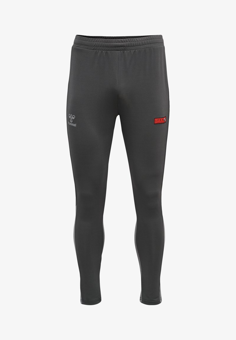 Leggings de sport gris foncé, coupe slim, avec taille élastique, logo Hummel sur la cuisse gauche, et un petit patch rouge "PRO" sur la cuisse droite.