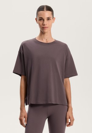 Tricou gri, cu croi lejer, mâneci scurte, decolteu rotund și deschideri laterale. Fabricat dintr-un material moale cu o textură fină și detalii de cusătură minime.