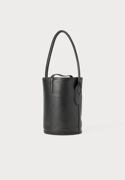 Black leather bucket bag with a smooth texture, rounded shape, and a long handle. Features a side pocket with a curved flap detail.
