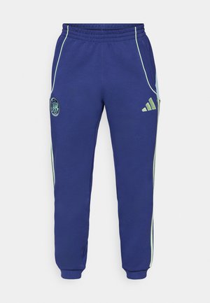 Pantalons de survêtement bleu marine avec des accents verts. Comprend une taille élastique, des poches latérales et un logo brodé sur la jambe gauche. Tissu doux.