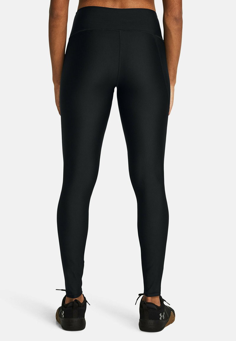 Zwarte leggings met een hoge tailleband, gemaakt van een glad, stretchmateriaal. Voorzien van een aansluitend ontwerp en sluit bij de enkels.