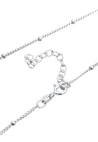 Sterling silver chain with rounded beads, featuring a lobster clasp and an adjustable length through linked segments. Shiny, smooth texture.