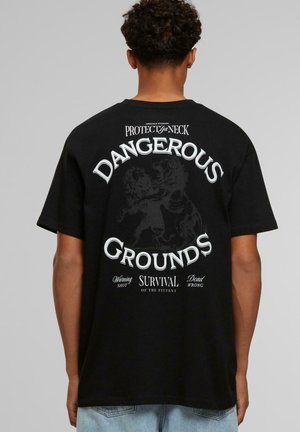 Black oversized t-shirt featuring white graphic text and lion illustration on the back, with a crew neckline and short sleeves.