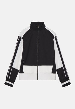 Jachetă zip-up alb-negru cu guler înalt, dotată cu dungi contrastante pe umeri și tivuri banded. Material moale cu un design minimalist.