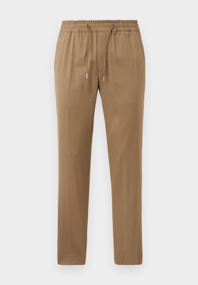 Brune joggebukser med elastisk talje og snørrebånd, der har en glat overflade og tapered ben, designet til komfort og bevægelsesfrihed.