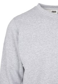 Sudadera gris claro hecha de una suave mezcla de algodón, con un diseño clásico de cuello redondo y mangas largas con una textura suave.
