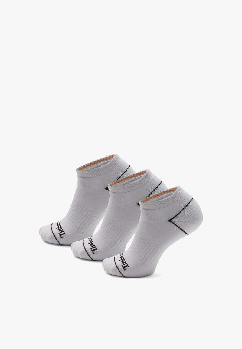 Chaussettes basses en coton blanc avec texture côtelée, bordure noire et détail logo sur les orteils. Trois paires alignées en rangée.