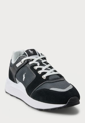 Black and gray athletic sneaker with white laces and cushioned white sole, featuring a stitched pony logo on the side and tongue.