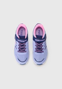 Pair of purple and pink Skechers children's sneakers with navy velcro straps and laces on a light background.