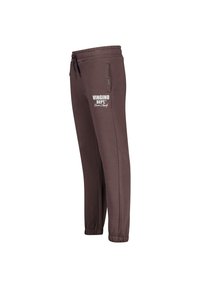 Bruine trainingsbroek met elastische tailleband en trekkoord. Beschikt over zijzakken en een witte logo-opdruk op de bovenbeen. Tapered leg ontwerp.