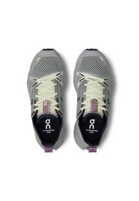 Light gray mesh trail shoes with yellow laces, purple accents, and cushioned sole. Features logo on tongue and heel for branding.