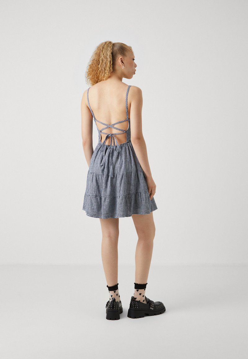 knee length dresses for ladies WOMEN'S SLEEVELESS HALTER NECK OPEN BACK TIERED RUFFLE MINI DRESS –  Wholesalefashiontrends.com