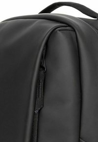 Black backpack: sleek, matte finish, soft texture, zipper detail on side, padded handle on top, contoured shape. Minimalistic design.