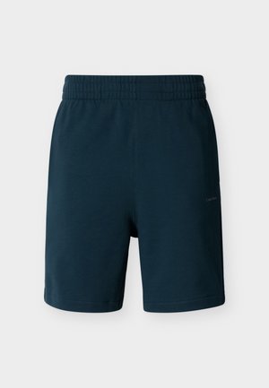 Pantaloni scurți bleumarin cu talie elastică, croială dreaptă și un logo subtil pe coapsa dreaptă, expuși pe un fundal neutru.