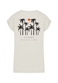 Light beige short-sleeve t-shirt featuring a black palm tree graphic and orange sun, with the text "ESCAPE AND DISCOVER THE WORLD."