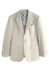 Beige bleiseri, jossa on teksturoitu pinta ja hienovarainen ruutukuvio, kukkakuosisella vuorilla ja siihen sopivalla taskuliinalla.