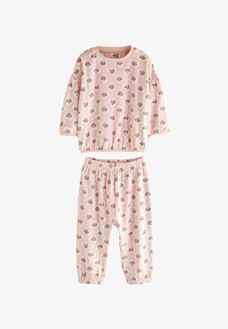 Completo in cotone rosa composto da due pezzi con stampa floreale, costituito da una maglietta a maniche lunghe e pantaloni con vita elasticizzata. Entrambi presentano polsini elasticizzati.