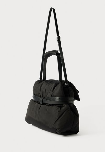 Μαύρη φουσκωτή τσάντα με κομψό σχέδιο, που διαθέτει υφή υφάσματος, δερμάτινο λουρί και μια ζώνη γύρω από τη μέση.