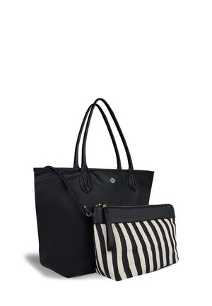 Black leather tote bag with braided handles, paired with a smaller striped black and cream pouch, featuring a zipper closure.