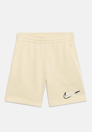 Μπεζ σορτς με ελαστική μέση, πλαϊνές τσέπες και μαύρο λογότυπο Nike Swoosh κεντημένο στο κάτω δεξί πόδι.
