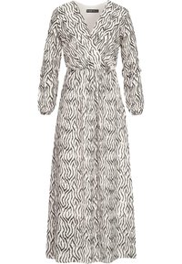 Robe longue en tissu léger, ornée d'un motif zèbre noir et blanc, avec des manches longues et un détail de taille nouée.