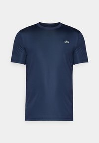 Mörkblå kortärmad T-shirt med rund hals och en liten grön krokodil-logotyp på vänster bröst.