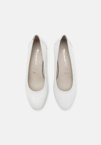 White ballet flats made of smooth leather with a rounded toe. Inside features soft cushioning with silver branding on the insole. Size 37.