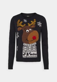 Zwarte langekousen trui met een glimlachende rendier dat gouden horens en een rode pomponneus draagt, versierd met witte sneeuwvlokken en feestelijke patronen.