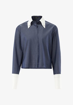 Kurzes Hemd aus dunkelblauem Stoff, mit einem kontrastierenden weißen Kragen und Manschetten mit dekorativer Stickerei. Lange Ärmel.