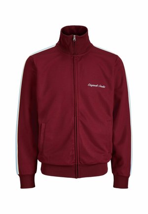 Vasakat värvi lukuga spordijakk valgete külgtriipude, kõrge krae, soonikkoes varrukasäärte ja alläärega ning tekstiga "Originals Studio" vasakul rinnal.