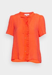 Short-sleeve orange button-up blouse with a ruffled front, textured fabric, and a small neckline tie detail. Lightweight and loose fit.