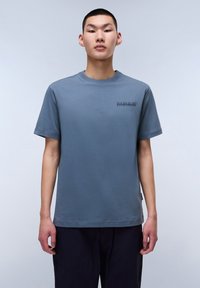 Blue cotton t-shirt with a round neckline and short sleeves, featuring a tonal embroidered logo on the chest, smooth texture, and relaxed fit.