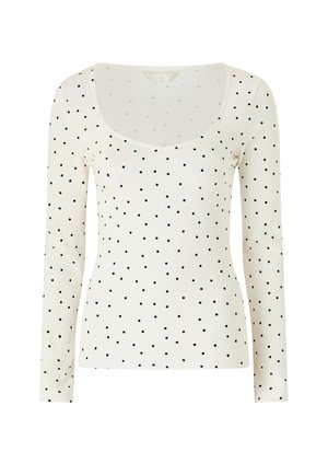 Hvid langærmet tætsiddende top med sorte polkaprikker og en bred, rund halsudskæring.