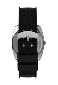 Bracelet de montre en caoutchouc noir avec un motif en diamant, fond de boîtier en acier inoxydable et boucle en argent. Nom de la marque "TIMEX" gravé sur la boucle.