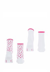 Weiße Socken mit rosa Punkten und kontrastierenden rosa Bündchen, die eine glatte Textur und ein strukturiertes Design zeigen.